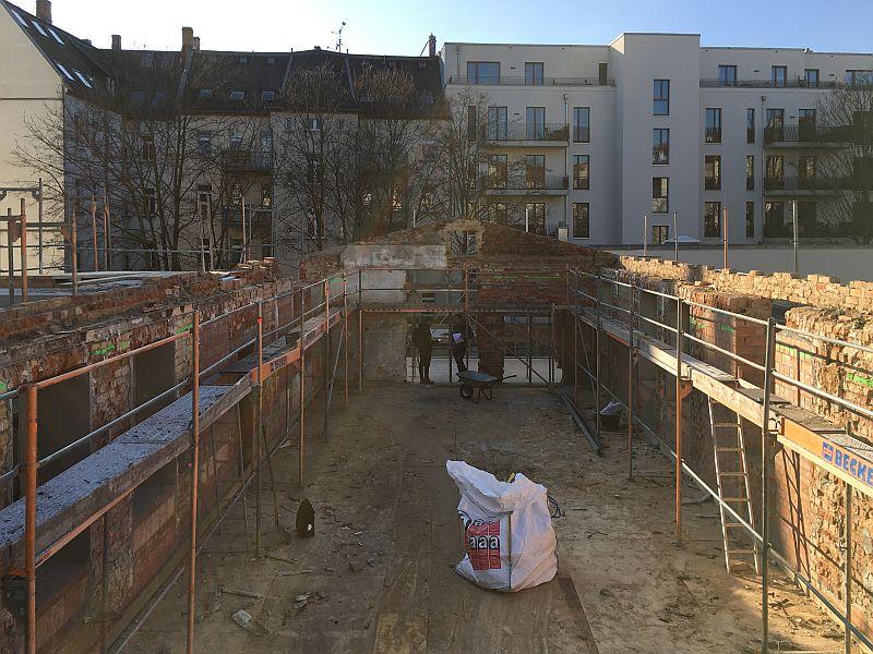 Auf dem Bild blickt man in ein Geschoss ohne Decke oder Dach. Das Dach wurde abgerissen. Jetzt soll eine Zwischendecke entstehen.